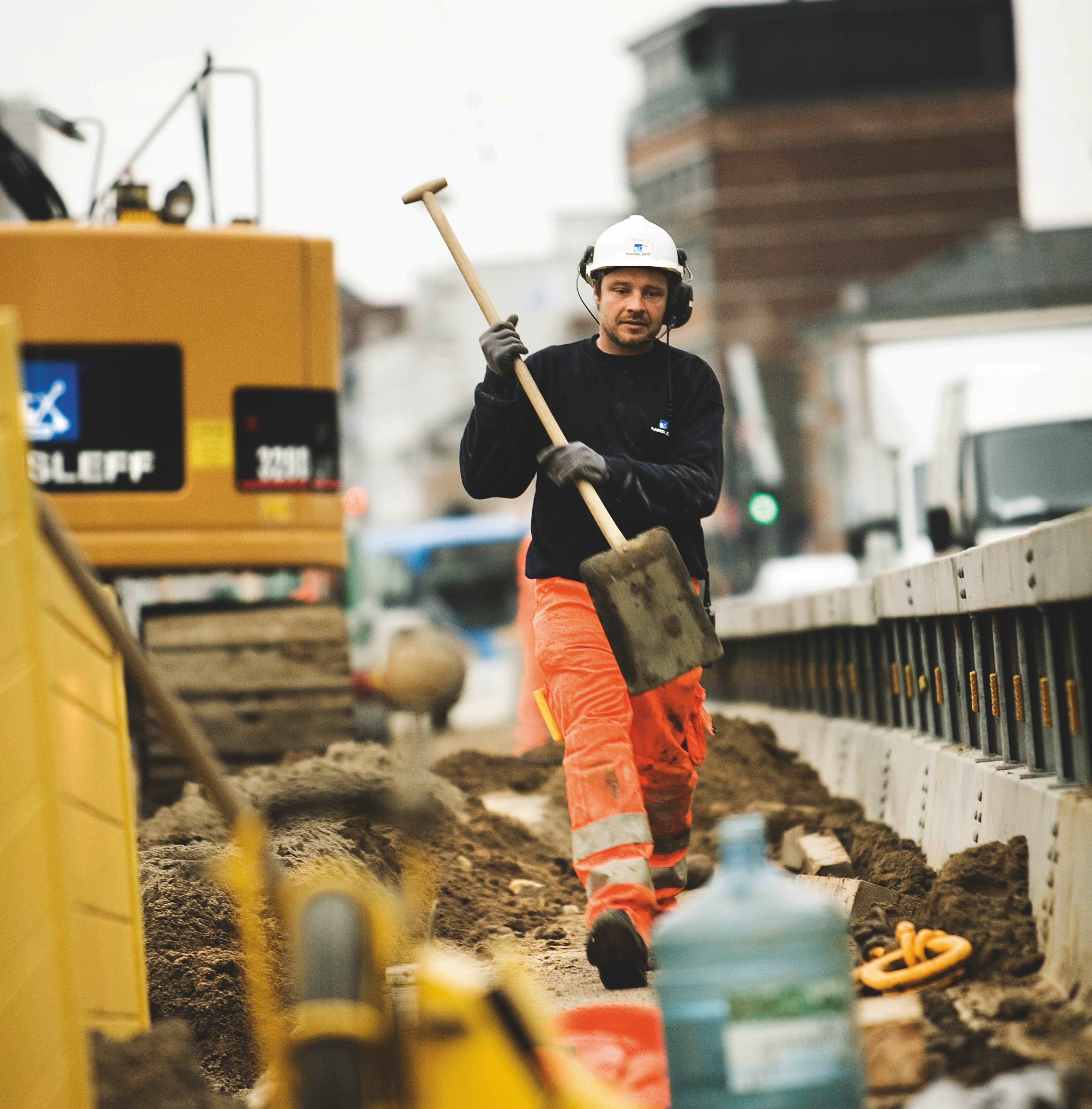 Aarsleff employee with shovel at the construction site